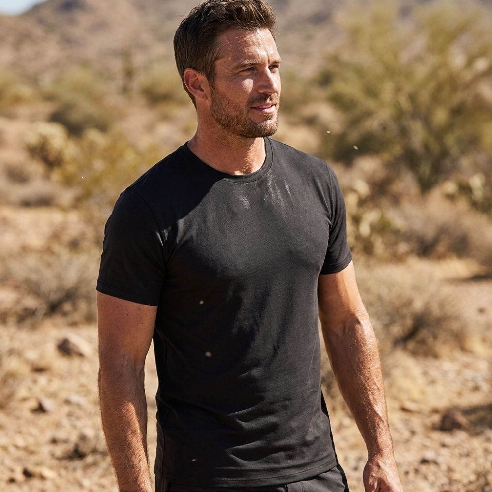 Man wearing a black t-shirt in a desert setting